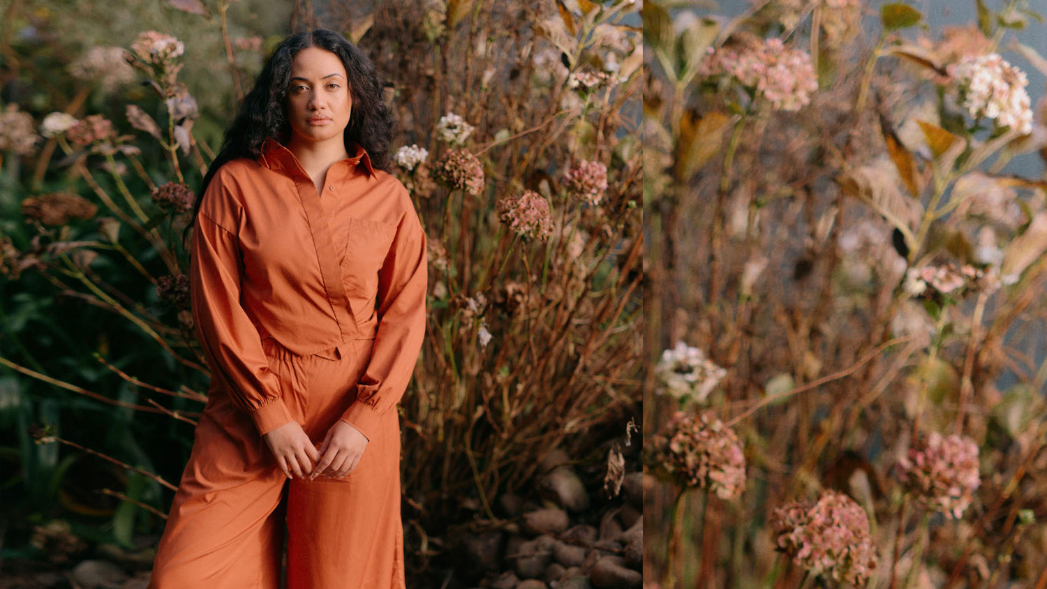Woman wearing a Burnt Sienna shirt and pants, standing in front of an autumn bush
